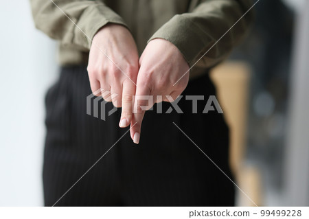A woman shows with index fingers down, a close-up A woman shows with index fingers down, a close-up 99499228