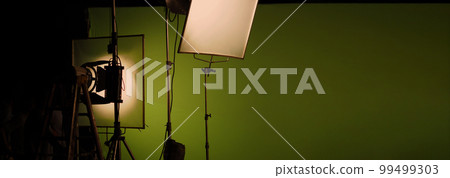 Film light for video production camera in studio set. Use as studio photo shoot light. Big LED spot light 5000w and diffuser or black panel create light like sun light can make daytime or golden hour Film light for video production camera in studio set. Use as studio photo shoot light. Big LED spot light 5000w and diffuser or black panel create light like sun light can make daytime or golden hour 99499303