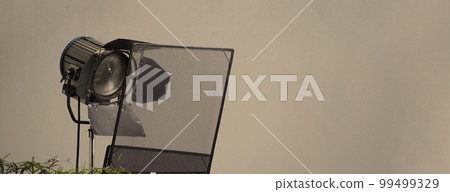 Film light for video production camera in studio set. Use as studio photo shoot light. Big LED spot light 5000w and diffuser or black panel create light like sun light can make daytime or golden hour 99499329