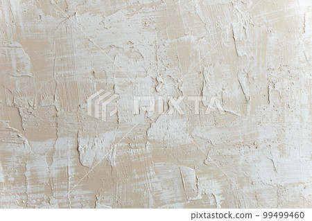 Decorative putty sample on the wall. Beige decorative plaster concrete textured background Decorative putty sample on the wall. Beige decorative plaster concrete textured background 99499460