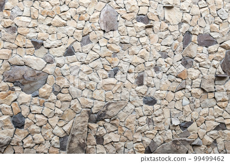 Texture of the stone wall, Abstract background. Coarse beige and gray stone. Stonework. Texture of the stone wall, Abstract background. Coarse beige and gray stone. Stonework. 99499462