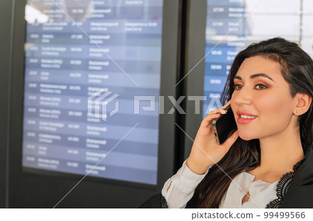 Girl at the airport desk waits for a flight Girl at the airport desk waits for a flight 99499566