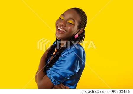 Black Female Laughing Out Loud Having Fun Over Yellow Background Black Female Laughing Out Loud Having Fun Over Yellow Background 99500436