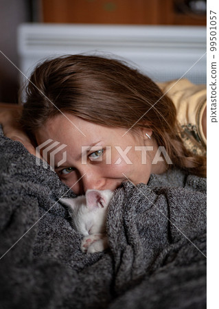 Portrait of a domestic cat of white color with big eyes. Cute clean cat. Portrait of a domestic cat of white color with big eyes. Cute clean cat. 99501057