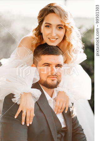 portrait of the bride gently embracing the groom. happy and loving newlyweds. portrait of the bride gently embracing the groom. happy and loving newlyweds. 99501303