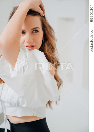 portrait of a seductive woman in a romantic top. portrait of a seductive woman in a romantic top. 99501304