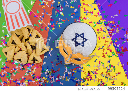 It is Jewish festival that is celebration with cookies, shofars, tallits, carnival masks, and hamantaschen symbols to celebrate Purim 99503224