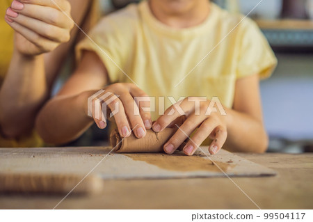 mother and son doing ceramic pot in pottery workshop mother and son doing ceramic pot in pottery workshop 99504117