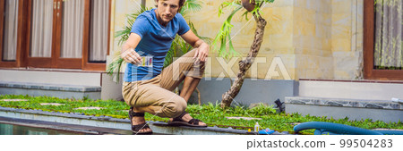 Pool worker checks the pool for safety. Measurement of chlorine and PH of a pool BANNER, LONG FORMAT 99504283