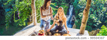 BANNER, LONG FORMAT Nepal Buddha copper singing bowl at spa salon. Young beautiful woman doing massage therapy singing bowls in the Spa against a waterfall. Sound therapy, recreation, meditation BANNER, LONG FORMAT Nepal Buddha copper singing bowl at spa salon. Young beautiful woman doing massage therapy singing bowls in the Spa against a waterfall. Sound therapy, recreation, meditation 99504387