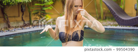 Young woman with disgust on his face pinches nose, something stinks, very bad smell in swimming pool because of pool chemicals. Negative emotion facial expression BANNER, LONG FORMAT Young woman with disgust on his face pinches nose, something stinks, very bad smell in swimming pool because of pool chemicals. Negative emotion facial expression BANNER, LONG FORMAT 99504390