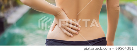 Women's back hurts against the backdrop of the pool. Pool helps with back pain BANNER, LONG FORMAT Women's back hurts against the backdrop of the pool. Pool helps with back pain BANNER, LONG FORMAT 99504391