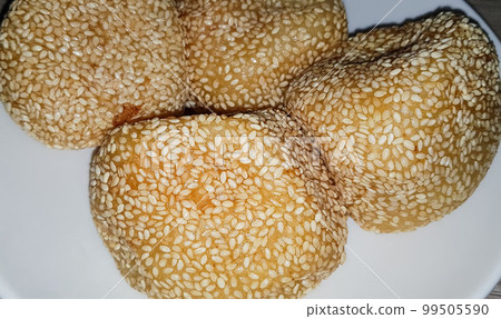 Onde-Onde is traditional food from Indonesia made from glutinous rice flour with beans pasta, wrapped in sesame seeds Onde-Onde is traditional food from Indonesia made from glutinous rice flour with beans pasta, wrapped in sesame seeds 99505590