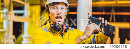 BANNER, LONG FORMAT Young man in a yellow work uniform, glasses and helmet in industrial environment,oil Platform or liquefied gas plant looking into his empty wallet. Do not pay salary BANNER, LONG FORMAT Young man in a yellow work uniform, glasses and helmet in industrial environment,oil Platform or liquefied gas plant looking into his empty wallet. Do not pay salary 99506358