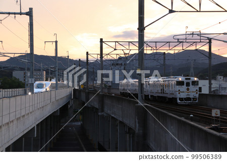 Nishikyushu Shinkansen N700S series Futsuboshi 4047 arriving at Takeo Onsen Station at dusk 99506389
