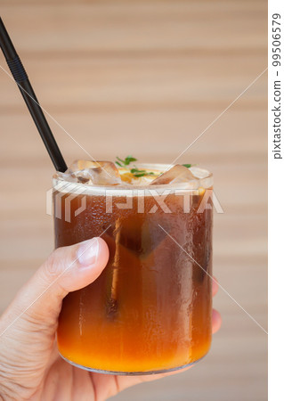 Iced coffee with orange in coffee shop Iced coffee with orange in coffee shop 99506579