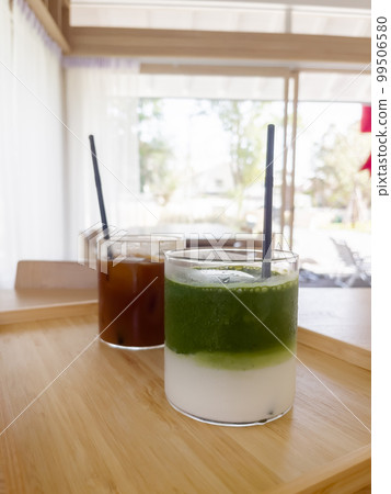 Iced americano with orange and iced matcha green tea in coffee shop 99506580