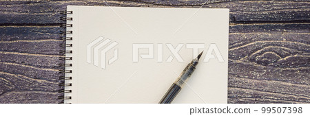 Women's hands in a wooden background holding a signboard, drawing block, paper, mockup BANNER, LONG FORMAT 99507398