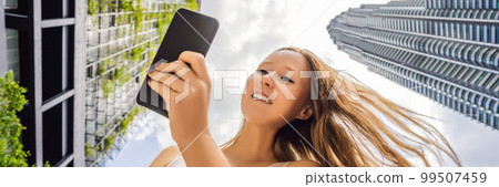 woman using map app on smartphone on the background of skyscrapers BANNER, LONG FORMAT woman using map app on smartphone on the background of skyscrapers BANNER, LONG FORMAT 99507459