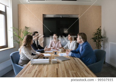 Business partners and mature female company CEO meeting in boardroom Business partners and mature female company CEO meeting in boardroom 99507935