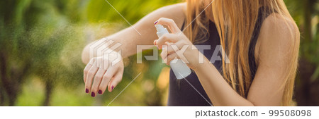 Woman spraying insect repellent on skin outdoor BANNER, LONG FORMAT 99508098