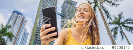 Woman Tourist using navigation app on the mobile phone. Navigation map on a smartphone in a big city BANNER, LONG FORMAT Woman Tourist using navigation app on the mobile phone. Navigation map on a smartphone in a big city BANNER, LONG FORMAT 99508143