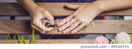 Young woman makes manicure with gel polish and UV lamp in pink shades BANNER, LONG FORMAT Young woman makes manicure with gel polish and UV lamp in pink shades BANNER, LONG FORMAT 99508354