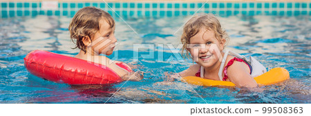 two little kids playing in the swimming pool BANNER, LONG FORMAT 99508363