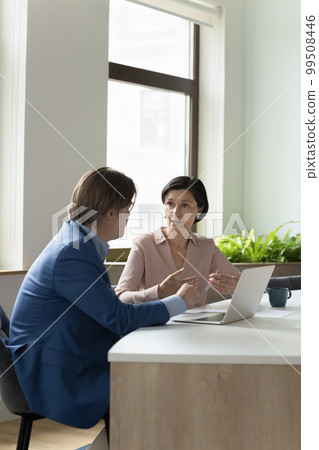 Couple of middle aged coworkers meeting at workplace 99508446