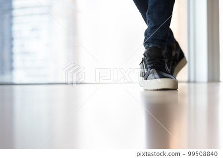 Trendy casual footwear on male feet close up shot 99508840
