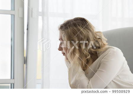 Pensive dreamy young woman lost in thoughts Pensive dreamy young woman lost in thoughts 99508929