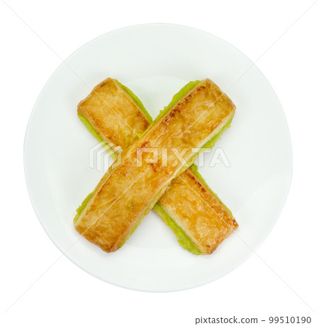 custard bread in a white plate isolated 99510190