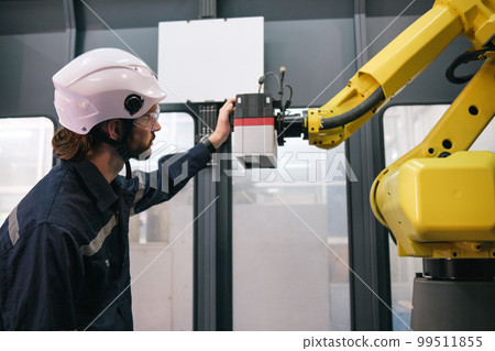 Engineer working in robotics factory 99511855