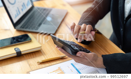 female employee working on a laptop computer in a modern office. Make an account analysis report. real estate investment information financial and tax system concepts female employee working on a laptop computer in a modern office. Make an account analysis report. real estate investment information financial and tax system concepts 99512697