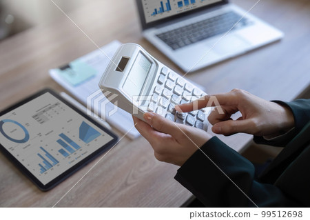 female employee working on a laptop computer in a modern office. Make an account analysis report. real estate investment information financial and tax system concepts female employee working on a laptop computer in a modern office. Make an account analysis report. real estate investment information financial and tax system concepts 99512698