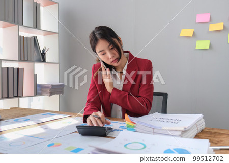 Businesswoman consultant talking on phone and calculating finance. freelance, tax, accounting, statistics and analytic research concept 99512702