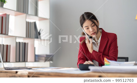 Businesswoman consultant talking on phone and calculating finance. freelance, tax, accounting, statistics and analytic research concept Businesswoman consultant talking on phone and calculating finance. freelance, tax, accounting, statistics and analytic research concept 99512703