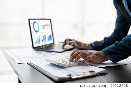 Businessman calculating the financial statement of his business. Accounting and Tax 99512708