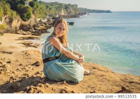 Young woman tourist on Pantai Tegal Wangi Beach, Bali Island, Indonesia. Bali Travel Concept 99513535