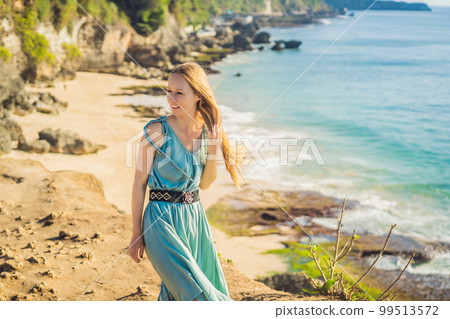 Young woman tourist on Pantai Tegal Wangi Beach, Bali Island, Indonesia. Bali Travel Concept Young woman tourist on Pantai Tegal Wangi Beach, Bali Island, Indonesia. Bali Travel Concept 99513572