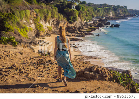 Young woman tourist on Pantai Tegal Wangi Beach, Bali Island, Indonesia. Bali Travel Concept 99513575