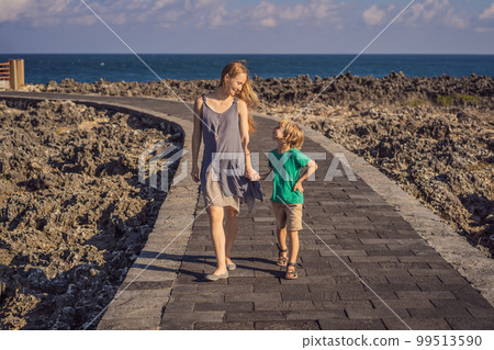 Mom and son travelers on amazing Nusadua, Waterbloom Fountain, Bali Island Indonesia. Traveling with kids concept 99513590