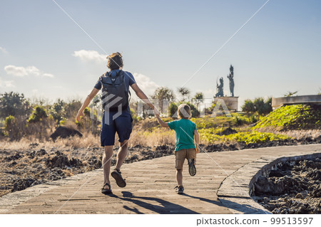 Father and son travelers on amazing Nusadua, Waterbloom Fountain, Bali Island Indonesia. Traveling with kids concept 99513597