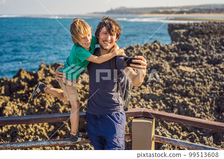 Father and son travelers on amazing Nusadua, Waterbloom Fountain, Bali Island Indonesia. Traveling with kids concept Father and son travelers on amazing Nusadua, Waterbloom Fountain, Bali Island Indonesia. Traveling with kids concept 99513608