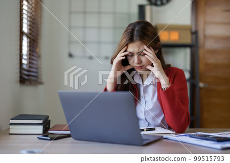 Tired young asian business woman with headache at office, feeling sick at work 99515793