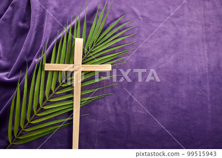 Lent season, Holy week and Good friday concept. Palm leave and cross on purple background Lent season, Holy week and Good friday concept. Palm leave and cross on purple background 99515943