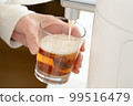 Female hand pouring beer from beer server 99516479