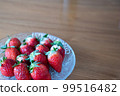 Fresh strawberries arranged in a glass bowl 99516482
