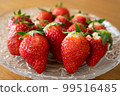 Fresh strawberries arranged in a glass bowl 99516485
