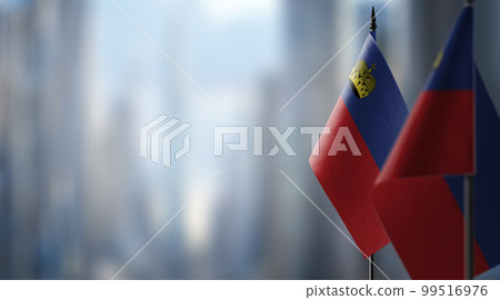 Small flags of the Liechtenstein on an abstract blurry background 99516976